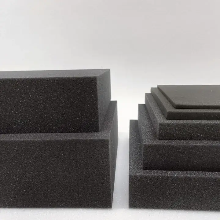 Dark charcoal foam cradles shaped to hold and protect industrial tools